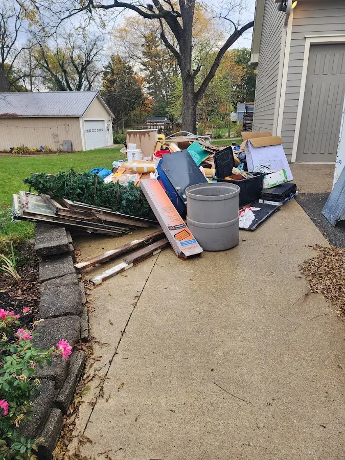 Dumpster being loaded with debris for Estate Cleanout Dumpster Rental in Lake of the Woods